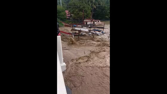 Strong river current floods toward the sea amid typhoon in Hamtic, Antique, Philippines