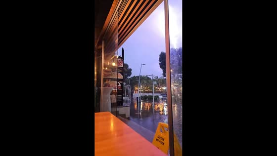 Lightning strike illuminates flooded street during storm in Salou, Spain