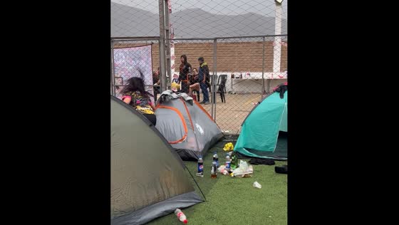 Tent in Lima appears to move as people laugh and record outside
