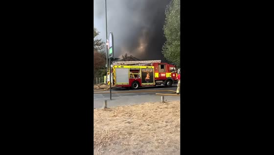 Large fire spreads to nearby field and house in Mitcham, UK