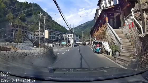 Debris thrown from a house shatters after hitting a passing car in Hangzhou, China