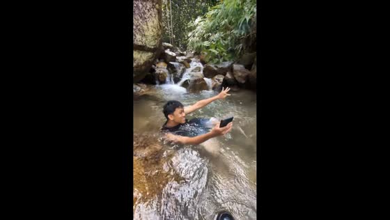 Friend panics over phone after slipping in shallow stream at Mount Pulai, Malaysia