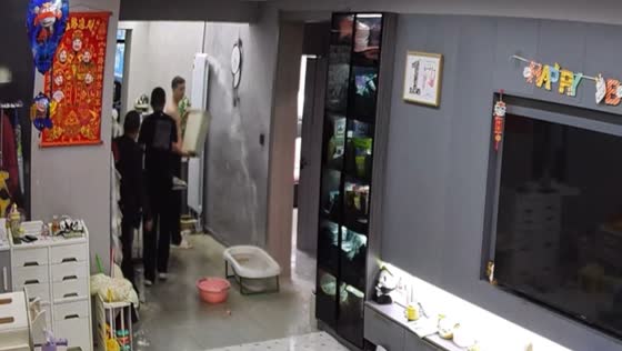 Residents scramble to catch water leaking from a pipe inside a house in Heilongjiang, China