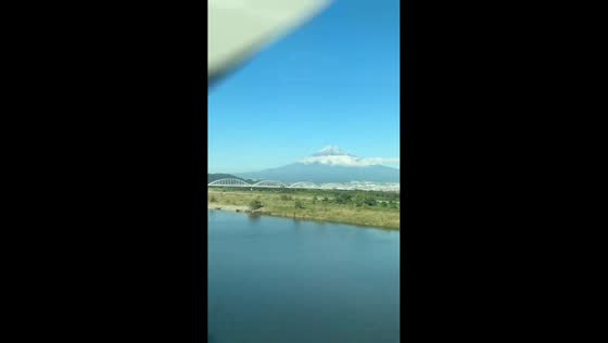 First snowfall of Mt. Fuji seen from bullet train in Shizuoka, Japan