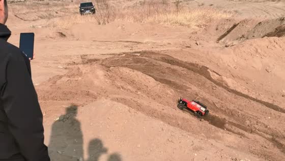 Toy car tackles slope in off-road field in Hebei, China