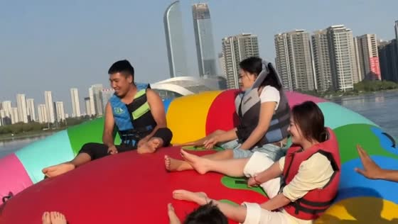 Riders tumble into water from spinning inflatable ride in Ningxia, China