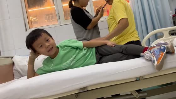 Child poses playfully on hospital bed in Inner Mongolia