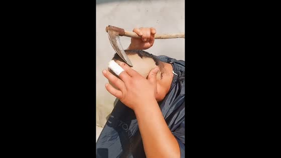 Man shaves his head with a sickle in an unusual haircut in Anhui, China