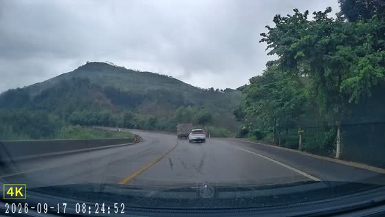 Car loses control and spins around curve on mountain highway in Guangxi, China