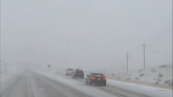 Blowing snow creates hazardous driving on US-40 near Parleys Summit in Utah, USA