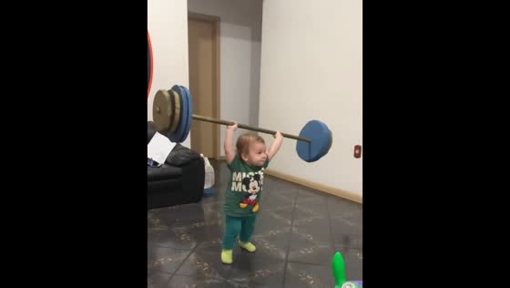 Little boy lifts toy barbell to applause in Brazil