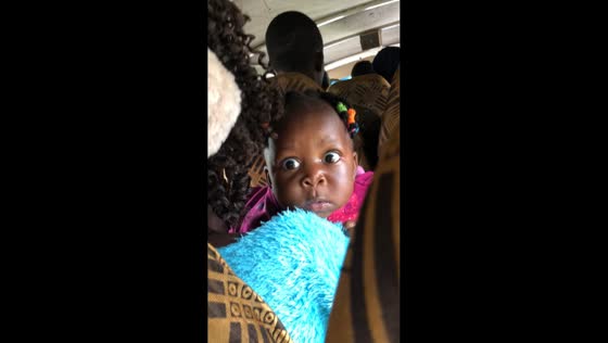 Baby’s curious stare inside vehicle in Kampala, Uganda