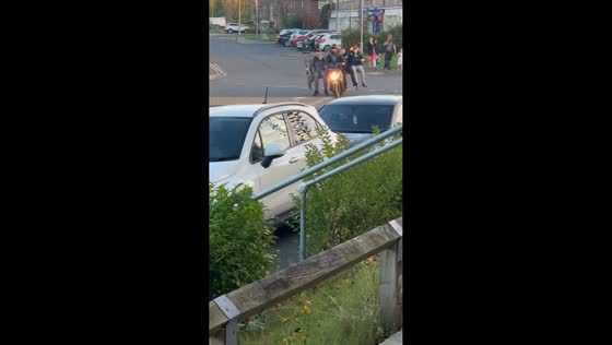 Men ride motorcycle with bench in St Helens, England, UK
