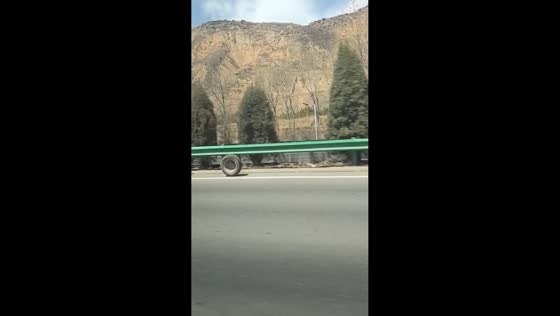 Runaway wheel rolls endlessly along roadside in Qinghai, China