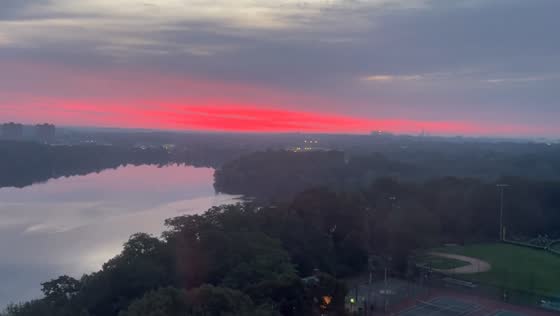 Vivid pink and red sunset with wildfire haze in Cambridge, Massachusetts