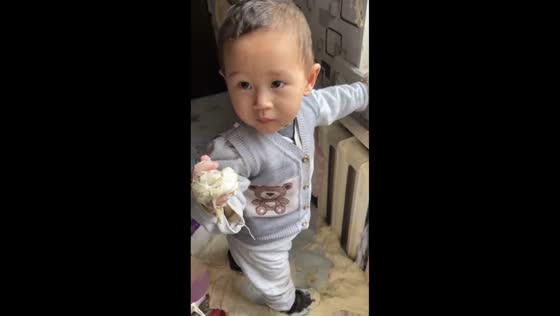 Baby makes dough mess in crib in Talas, Kyrgyzstan