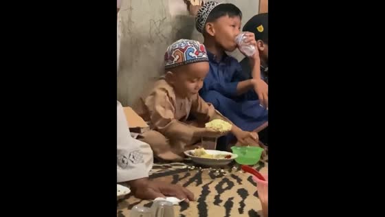 The little boy has a big appetite and eats a lot of rice!