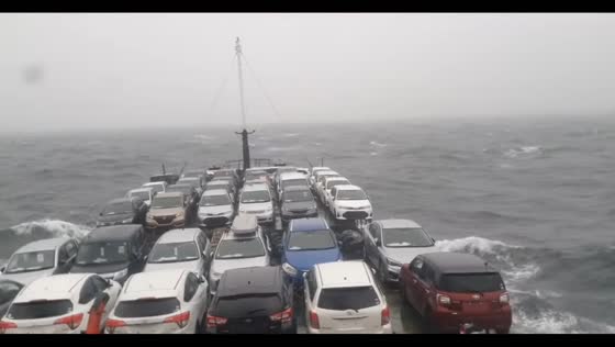 Ship carrying vehicles sways in rough sea but remains secure in Japan