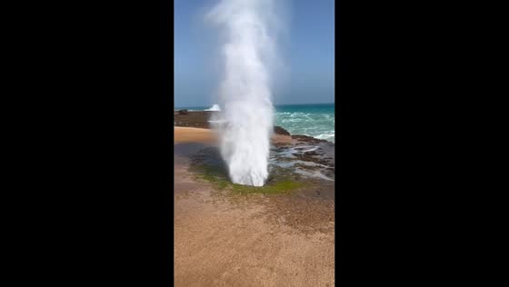 Waves create fountain effect through shoreline hole in Henan, China