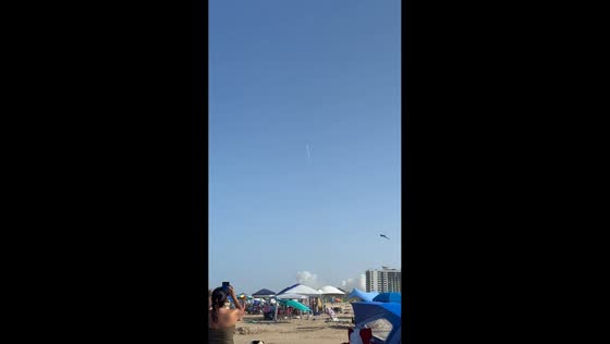 Beachgoers watch SpaceX's Starship Flight 13 launch in South Padre Island, Texas, USA