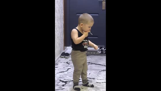Child mimics smoking and drunken walk in Tashkent, Uzbekistan