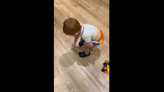 Toddler plays with spider in Cromdale, UK