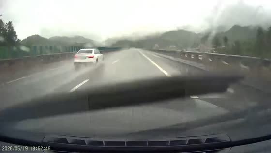 Car spins out and crashes into guardrail during heavy rain in Hunan, China