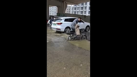 E-bike rider gets stuck in muddy pothole in Guangdong, China