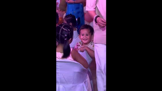 Love blossoms at a birthday party: tender smiles of a toddler