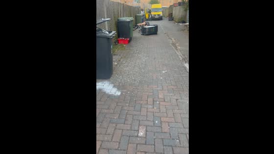 Cyclist loses control while pulling trash bin
