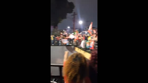 Supporters celebrate Lula’s reelection from an overpass in Curitiba, Brazil