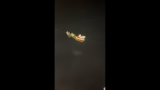 Flying santa riding a sleigh and waving to people in Montreux, Switzerland