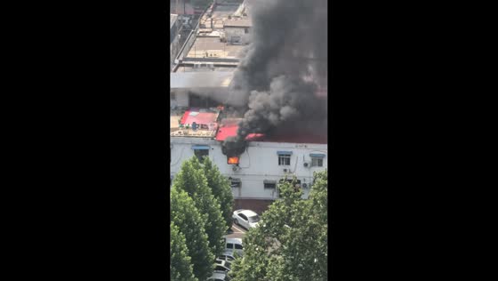 Thick black smoke rises from building fire in Hebei, China