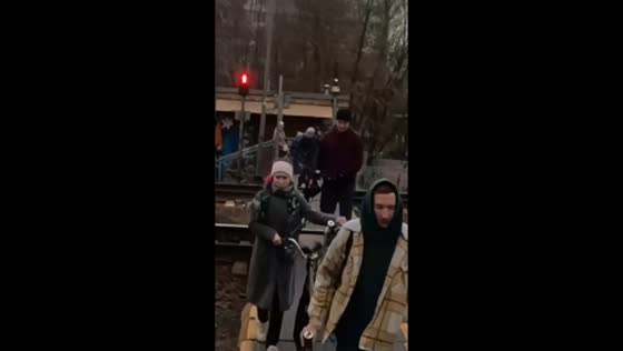 Woman narrowly avoids being hit by train in Bolshyevo Station, Korolyov, Moscow Oblast, Russia