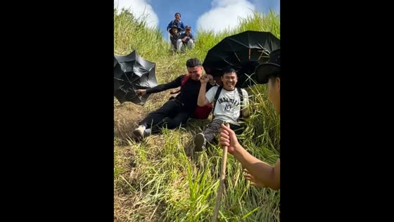 Friends slip while hiking down hillside in Bagumbayan, Sultan Kudarat, Philippines