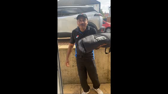 Domino’s delivery man sings along in Newport, England, UK