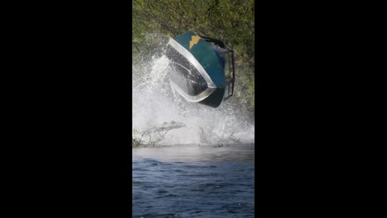 Mini jet boat hits log and ramps briefly on Rogue River in Oregon, USA