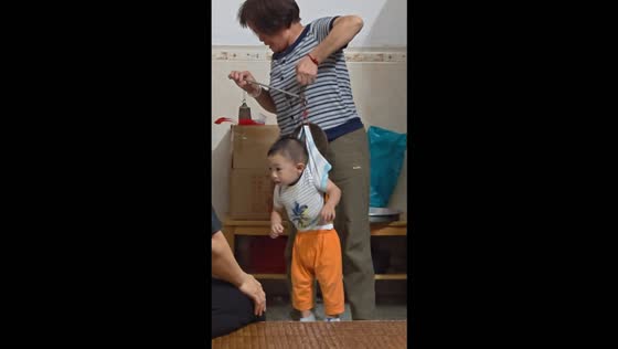 Woman weighs a child using a traditional Chinese medicine scale in Guangxi, China