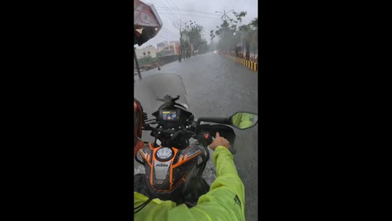 Motorcyclist helps woman stranded in floodwaters in Bilaspur, India
