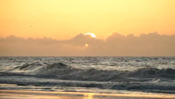 Sunset and strong waves at Surfside Beach, South Carolina, USA