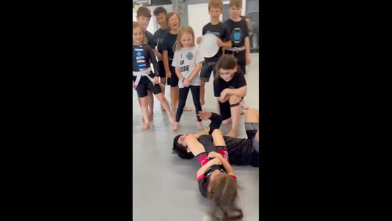 Kid performs juji gatame during mma training in Port Orange, Florida, USA