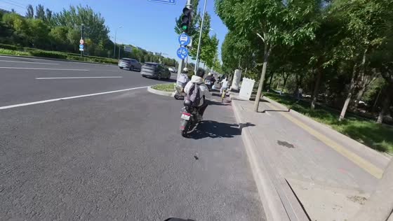 E-bike rider hits roadside curb and falls while entering bike lane in Beijing, China