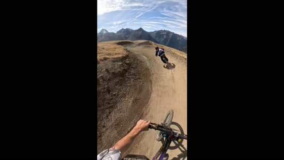 Mountain biker crashes into friend after a jump in Vénosc, France