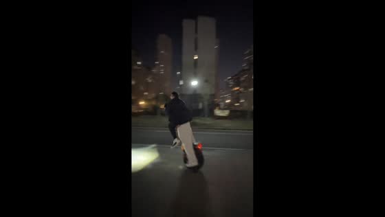Man rides electric unicycle while carrying friend in Jiangxi, China