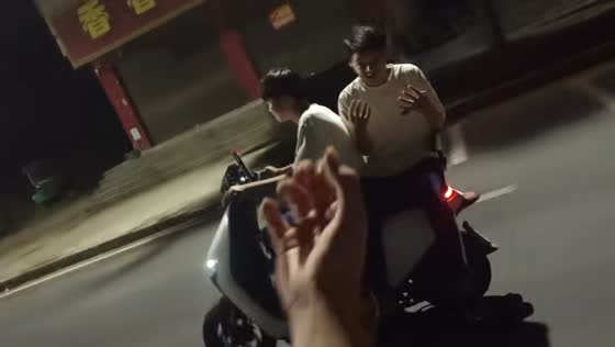 E-scooter passenger jumps off and falls on a road at night in Hunan, China
