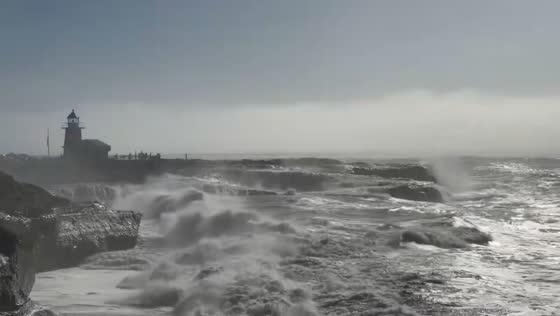 Powerful waves crash along the shore in Santa Cruz, California, USA