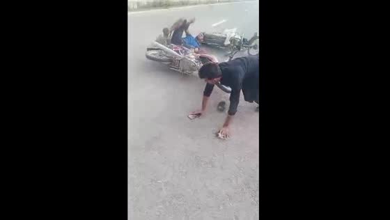 Motorcyclist helps bird, gets hit and falls