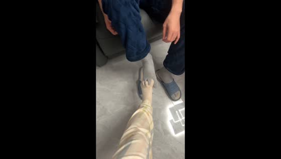 Couple laughs as toe socks interlock like holding hands in Heilongjiang, China 