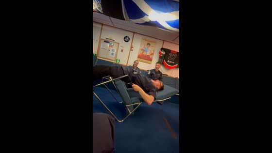 Man performs strength stunt using a chair in Portsmouth, England, UK