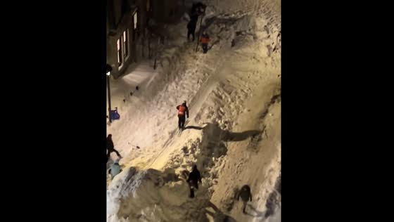 People ski through snow-filled streets in Montreal after snowstorm